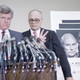 Dingell, standing behind former senator Ted Kennedy at an Alzehimer’s bill announcement, 1987.